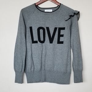 Love sweater with decorative ruffle